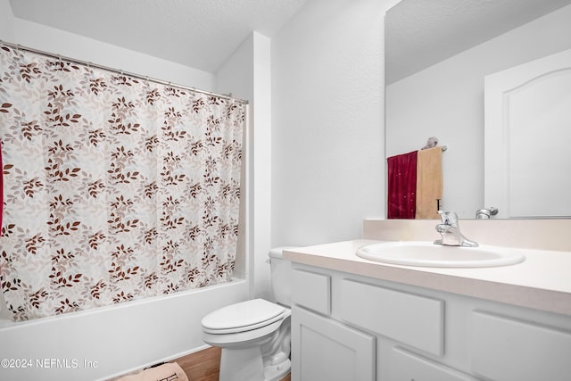 2035 Garrison Way, Green Cove Springs, FL 32043 - full bathroom featuring hardwood / wood-style floors, shower / bath combination with curtain, vanity, toilet, and a textured ceiling