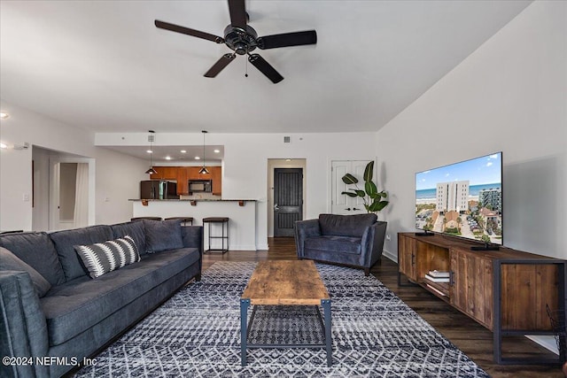 living room with ceiling fan and dark wood-type flooring