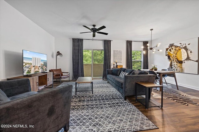 living room with plenty of natural light, ceiling fan with notable chandelier, and hardwood / wood-style flooring