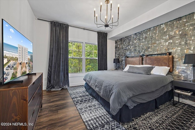 bedroom featuring dark hardwood / wood-style flooring and an inviting chandelier