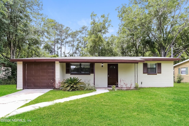 single story home featuring a garage and a front lawn