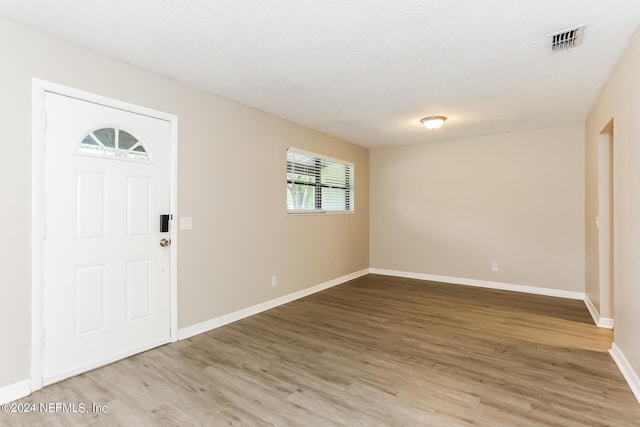 entryway featuring hardwood / wood-style floors and a textured ceiling