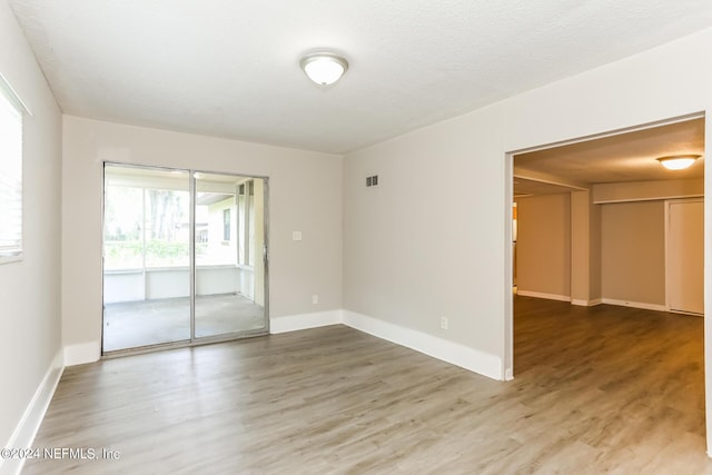 unfurnished room featuring hardwood / wood-style flooring