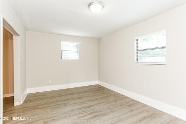 spare room featuring hardwood / wood-style flooring and a wealth of natural light