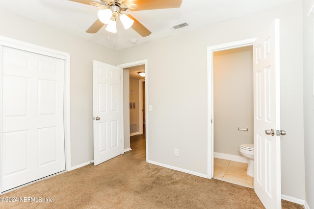 unfurnished bedroom featuring carpet floors, a closet, and ceiling fan