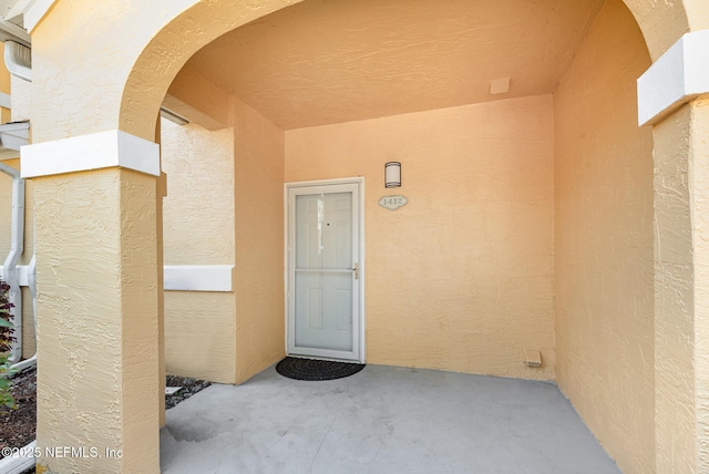 doorway to property with stucco siding