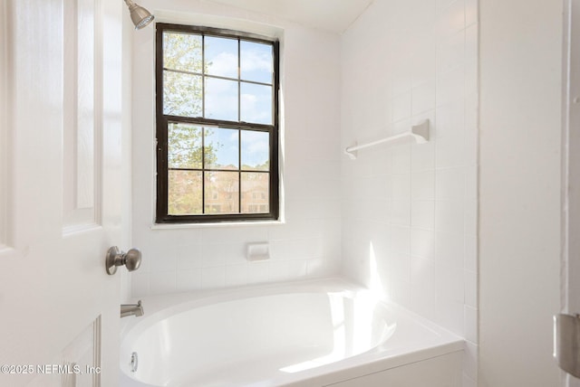 bathroom featuring a shower and a bathing tub