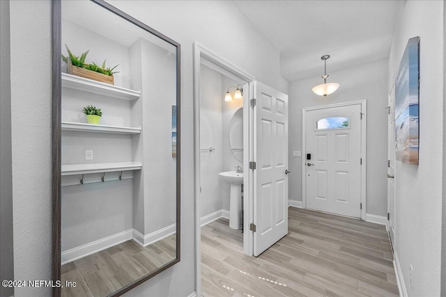 entryway with sink and light hardwood / wood-style floors