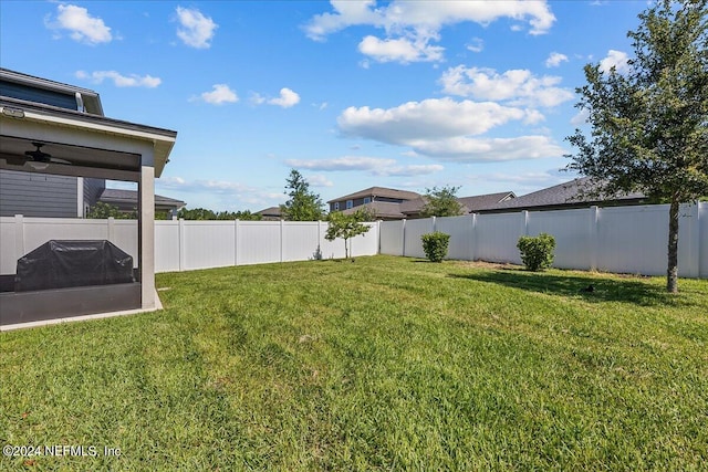 view of yard with ceiling fan