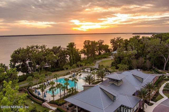 aerial view at dusk with a water view