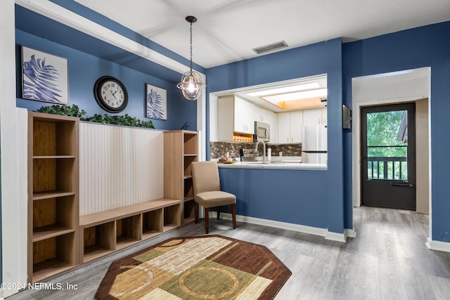 interior space featuring sink and light hardwood / wood-style floors