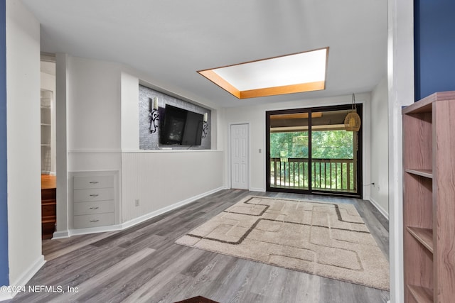 unfurnished room with hardwood / wood-style flooring