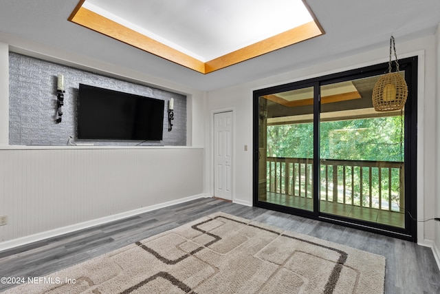 empty room featuring wood walls and dark wood-type flooring