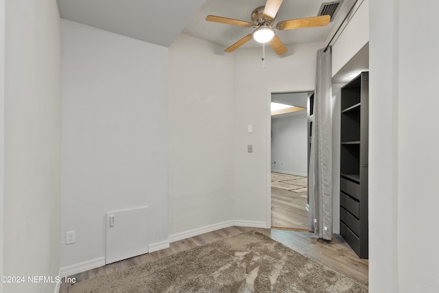 empty room with light hardwood / wood-style floors and ceiling fan