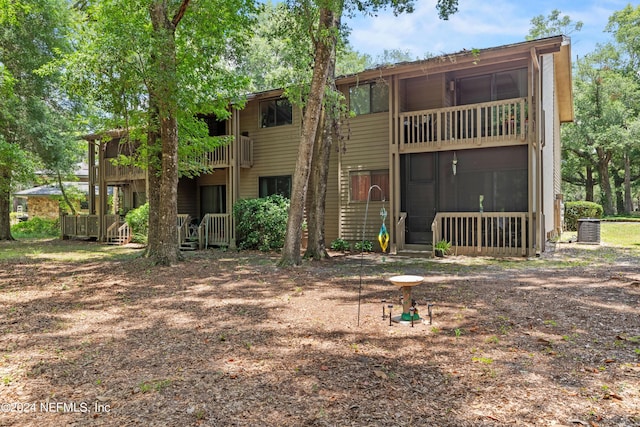 back of house featuring a balcony