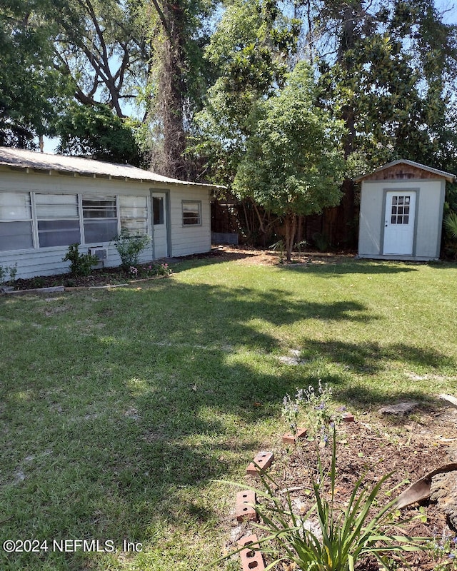 view of yard with a storage shed and an outbuilding