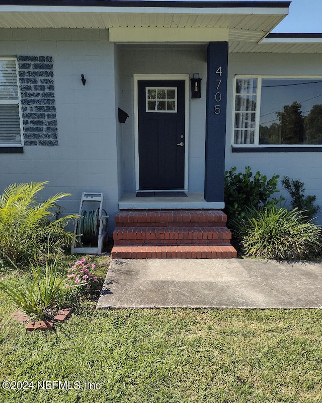 property entrance with concrete block siding