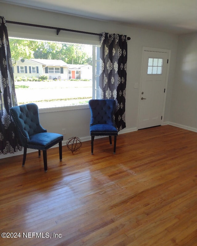 living area featuring baseboards and wood finished floors