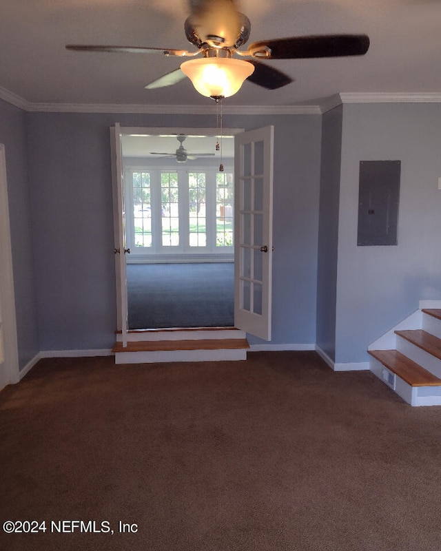 interior space with ornamental molding, electric panel, dark carpet, and baseboards