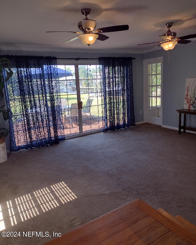 carpeted spare room featuring ornamental molding and baseboards