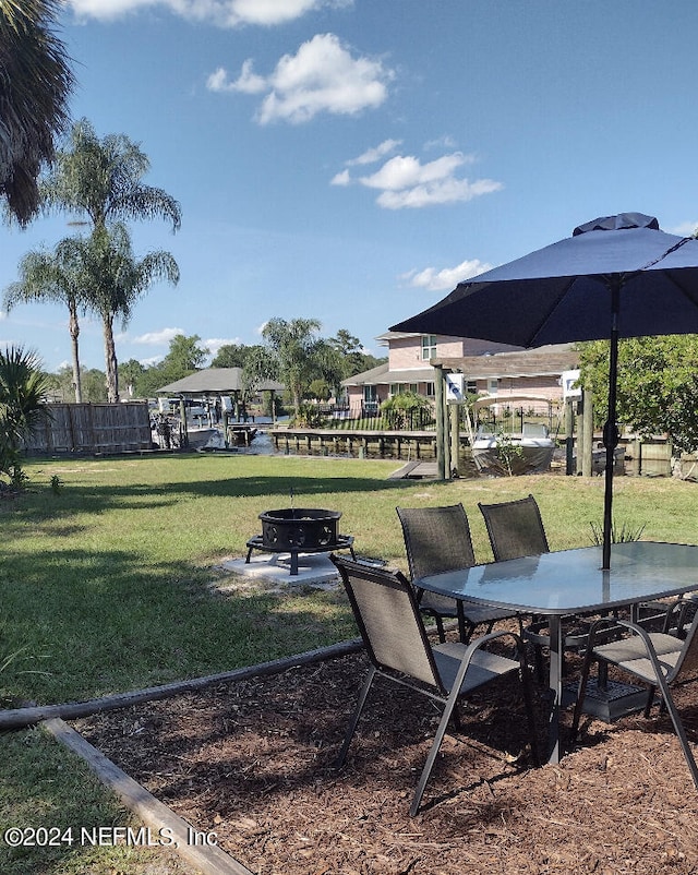 view of yard with an outdoor fire pit and fence