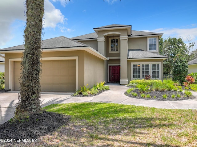 view of front of house with a garage and a front lawn