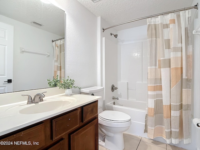 full bathroom featuring vanity, tile patterned floors, toilet, a textured ceiling, and shower / tub combo with curtain