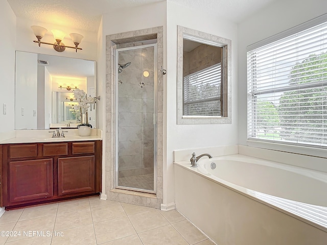 bathroom with tile patterned floors, vanity, a textured ceiling, and independent shower and bath