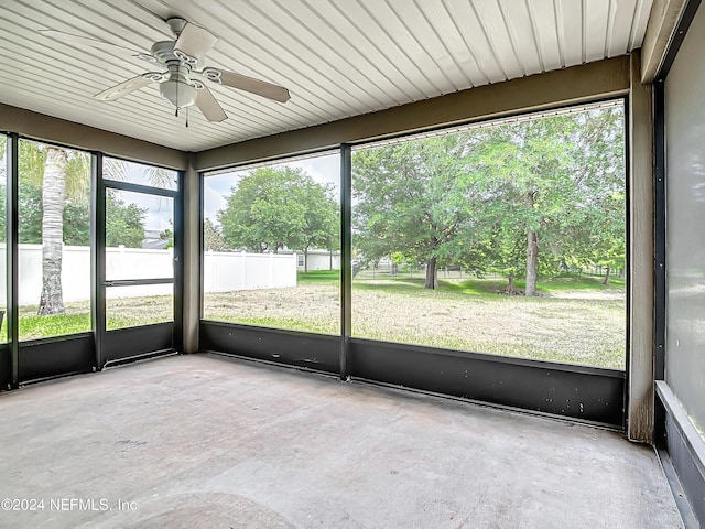 unfurnished sunroom with plenty of natural light and ceiling fan