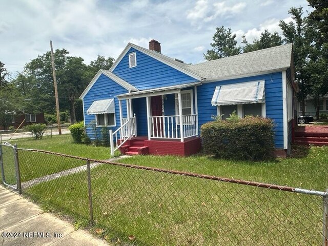 bungalow-style home with a front yard