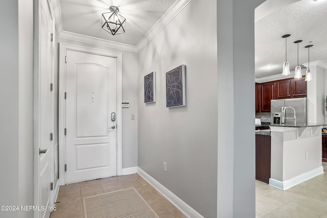 interior space with ornamental molding, a textured ceiling, and light tile patterned flooring