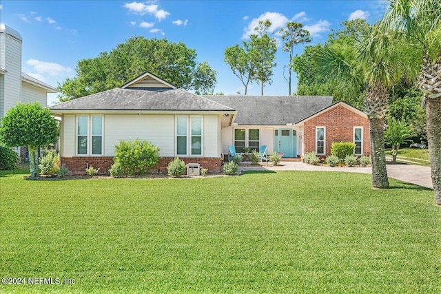 rear view of property featuring a yard