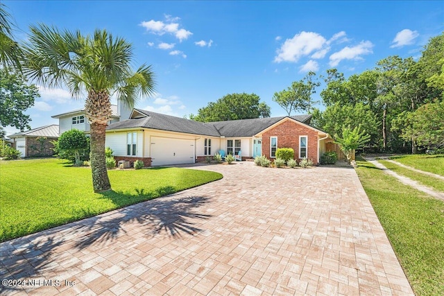 ranch-style house with a garage and a front yard