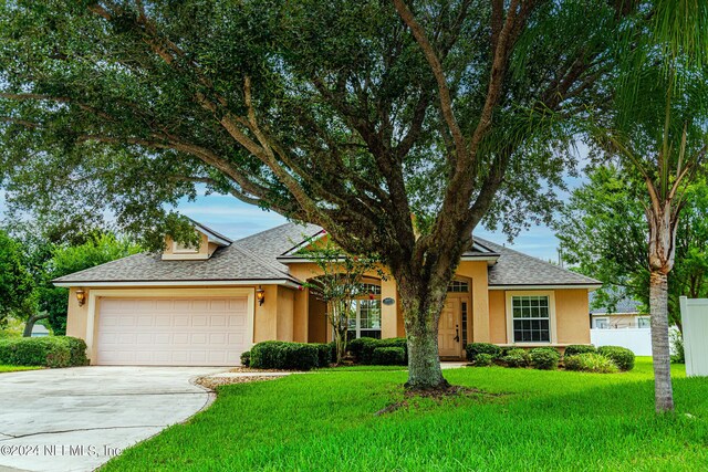 view of front facade with a garage and a front yard