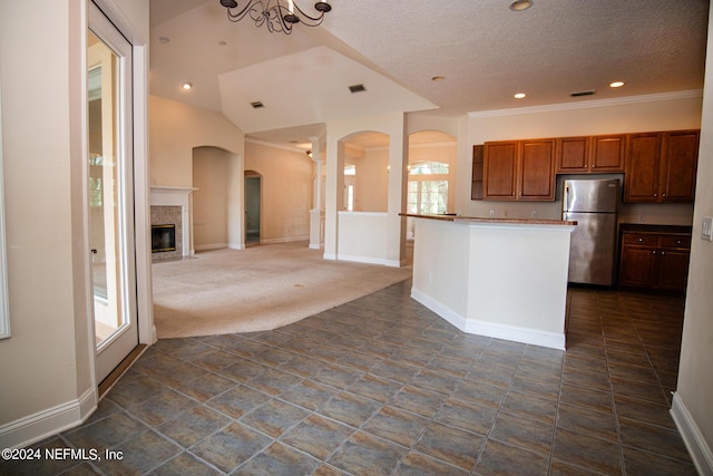 kitchen with recessed lighting, dark carpet, brown cabinetry, freestanding refrigerator, and baseboards