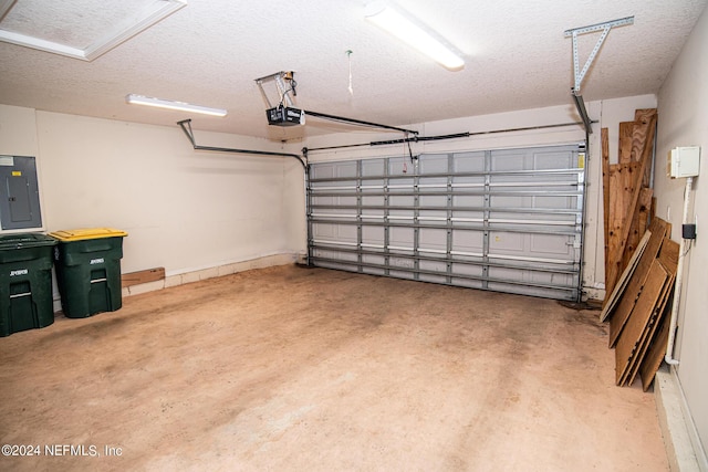 garage featuring electric panel and a garage door opener