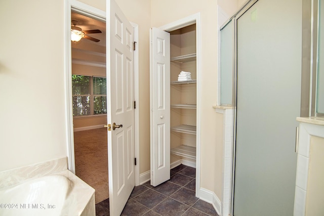 bathroom with a stall shower, a walk in closet, a bath, and tile patterned floors