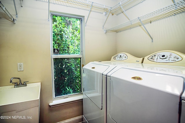 laundry area with a sink, laundry area, and washing machine and dryer