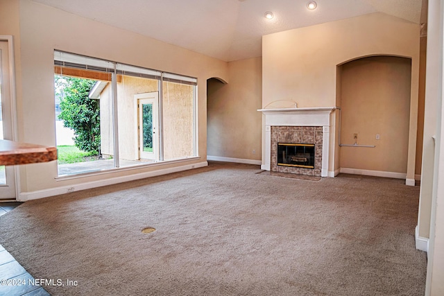 unfurnished living room with vaulted ceiling, carpet floors, a fireplace, and baseboards