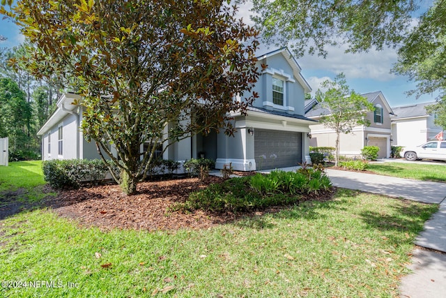 obstructed view of property with a front yard and a garage