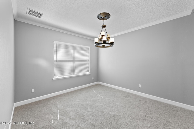 empty room featuring carpet, a chandelier, a textured ceiling, and ornamental molding