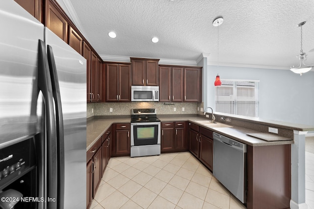 kitchen with decorative light fixtures, stainless steel appliances, crown molding, and sink