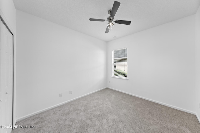 unfurnished room featuring carpet flooring, a textured ceiling, and ceiling fan