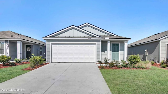 view of front of home featuring a garage and a front lawn