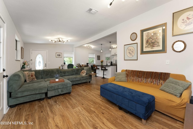 living room featuring light wood-type flooring and lofted ceiling