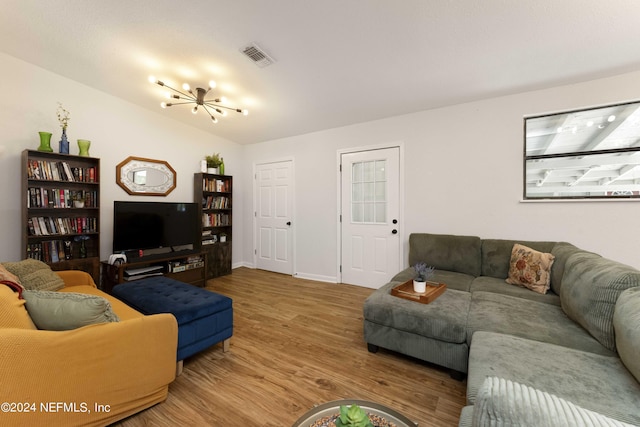 living room featuring wood-type flooring and a notable chandelier