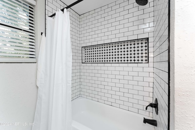 bathroom featuring plenty of natural light and shower / bath combination with curtain