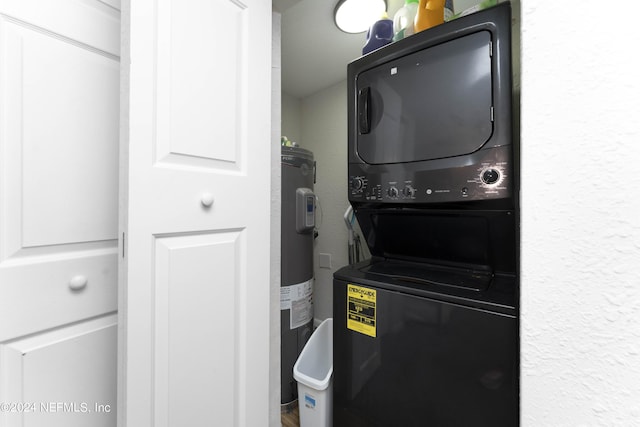 laundry area with water heater and stacked washer and dryer