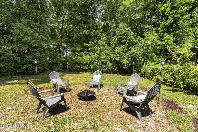 view of yard featuring an outdoor fire pit