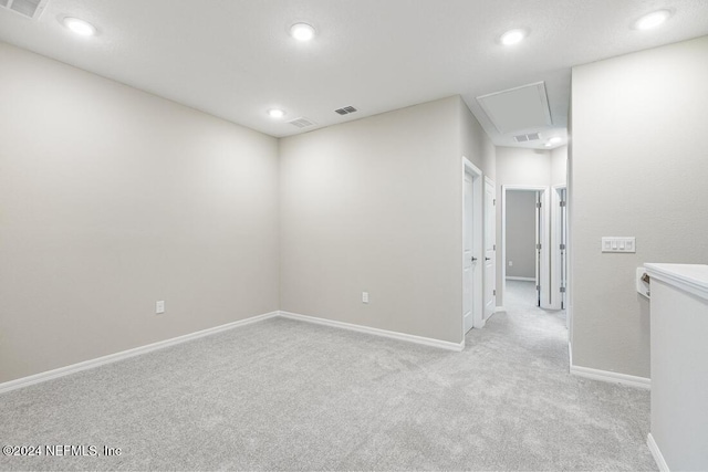 spare room featuring light colored carpet